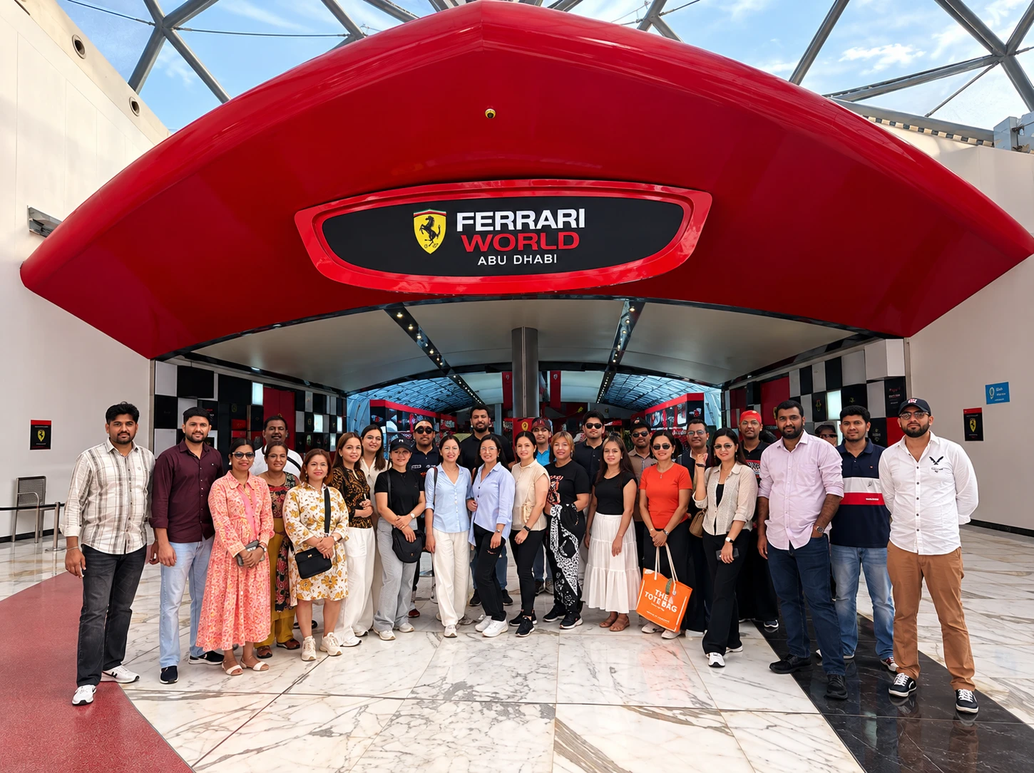 Guests posing under the red Ferrari World Abu Dhabi entrance