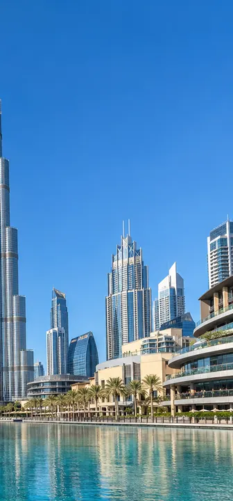 The Burj Khalifa and Downtown Dubai across the lake on a bright sunny day